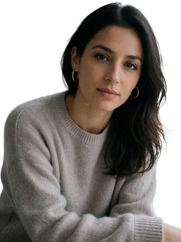 Jordanian woman in a dove-grey sweater with a thoughtful, gentle expression