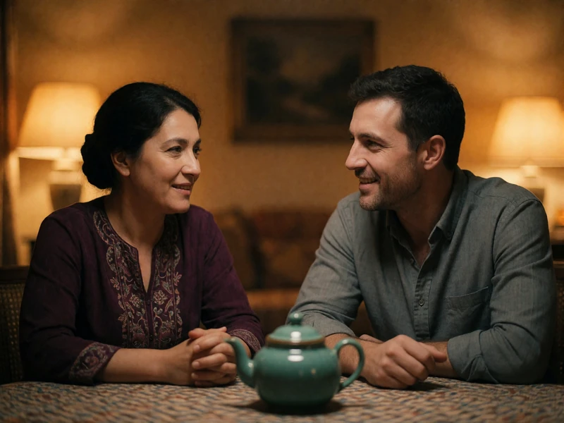 Tajik woman in a deep plum tunic and a Western man mid-conversation across a low table with a teapot between them