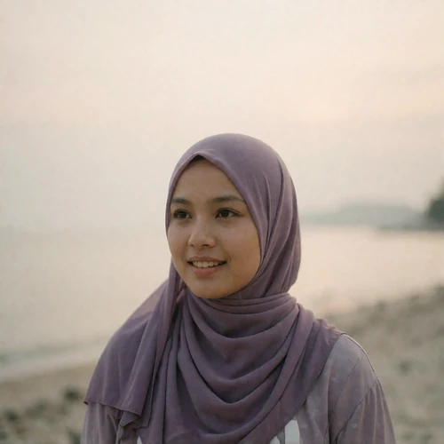 Bruneian woman in her mid twenties wearing a muted lavender scarf with a soft candid smile