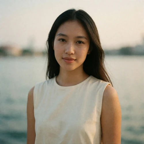Singaporean woman in her late twenties wearing an ivory top, an example EasternSingles member profile photo